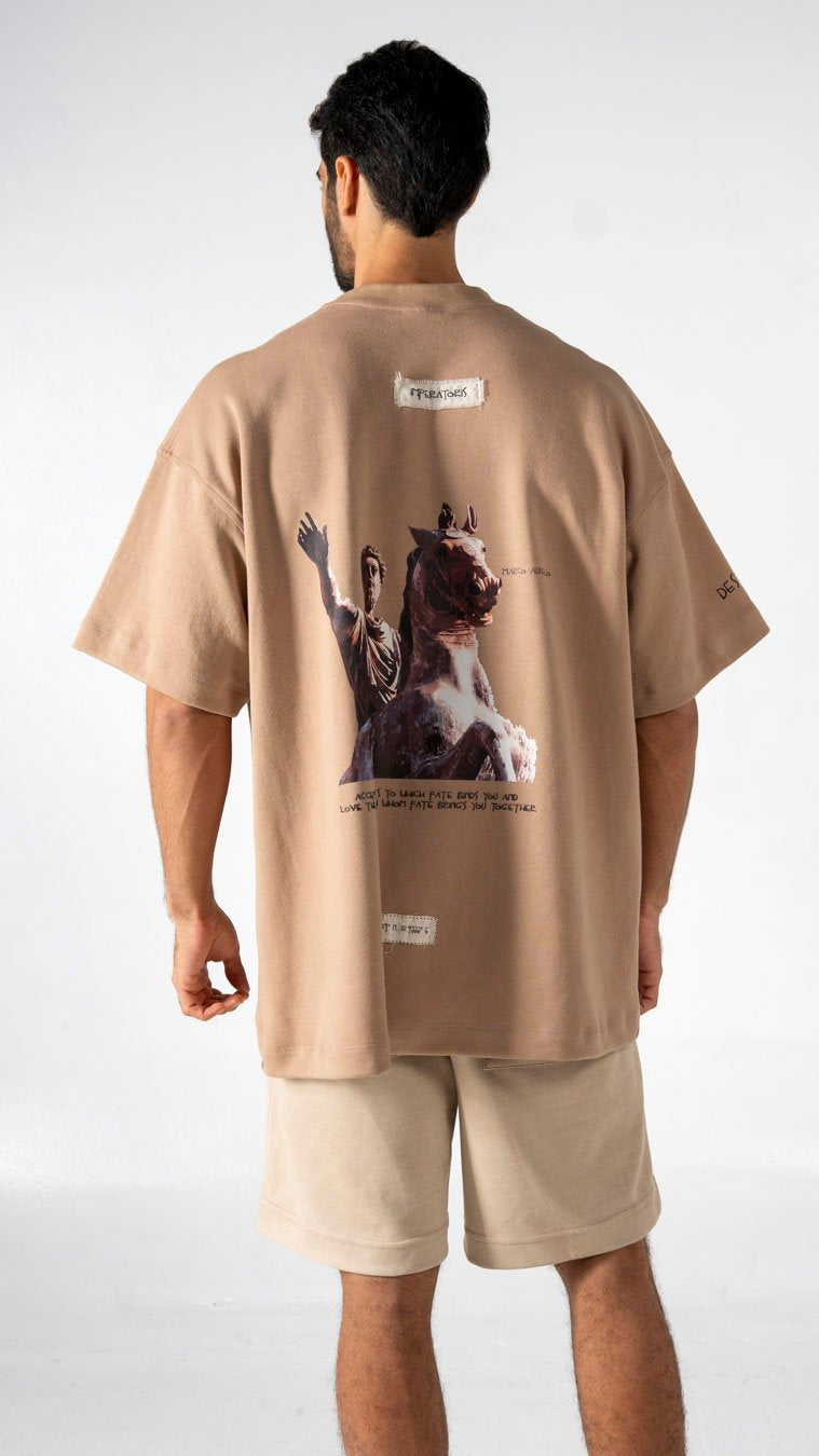 Men's oversized beige graphic t-shirt with artwork and text, casual streetwear fashion.