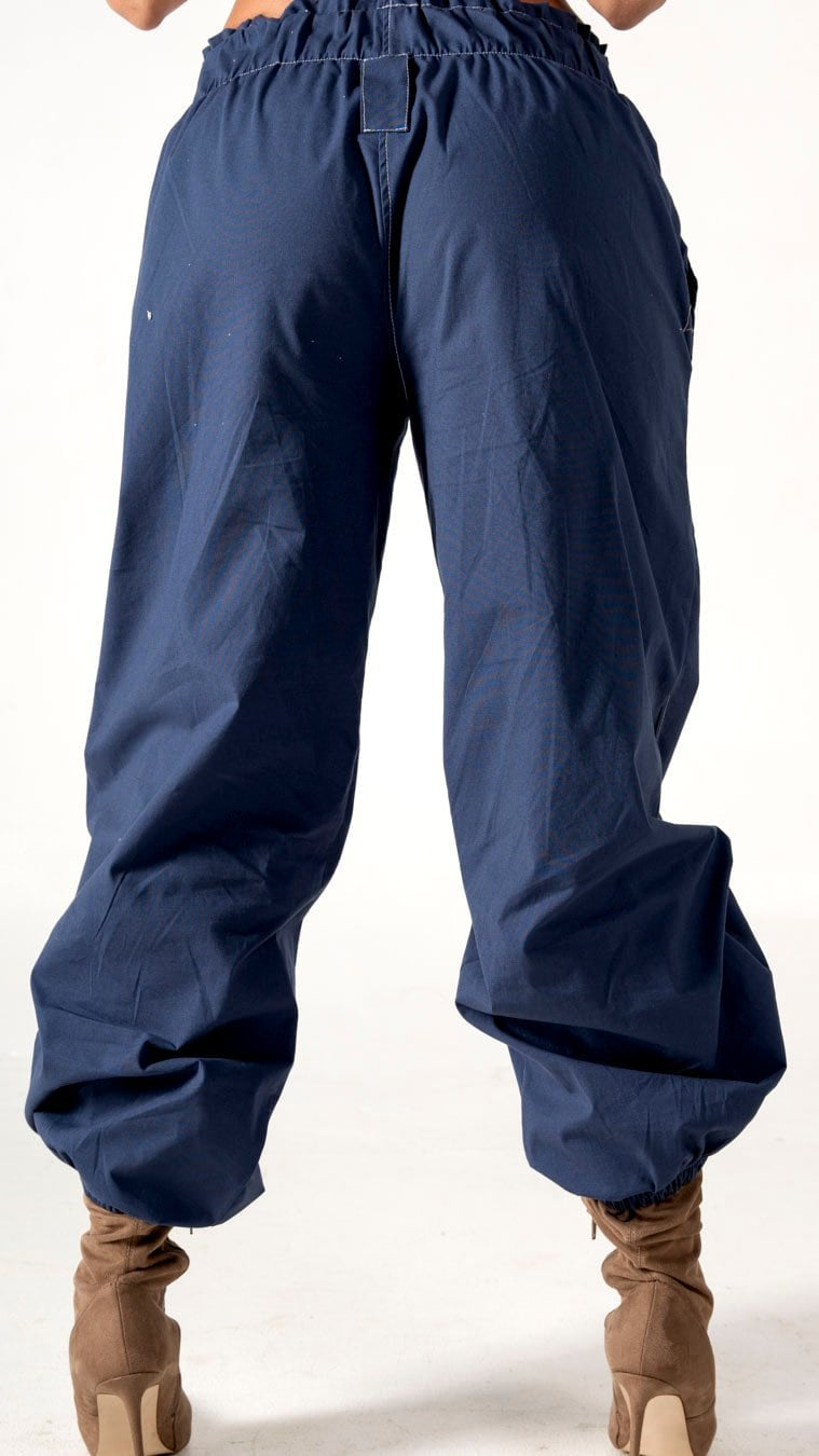 Relaxed fit navy blue cargo pants with elastic cuffs, perfect for casual and streetwear styles, paired with beige high-heeled ankle boots. High-quality fabric offers comfort and durability for everyday wear.