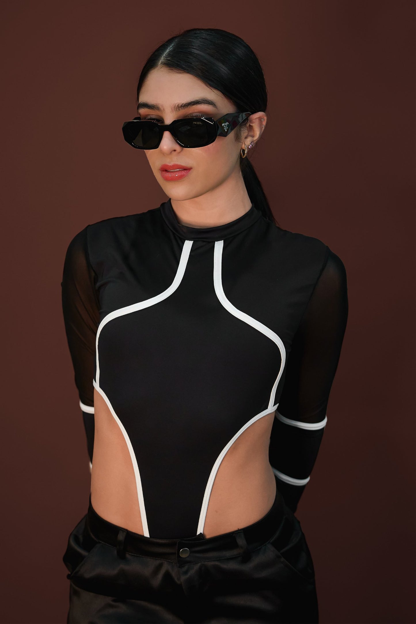 Black designer sunglasses with bold frames and logo detail.