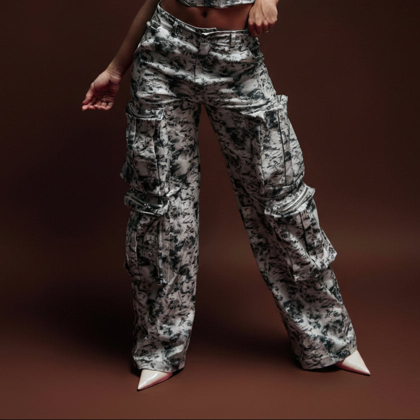 Bold camouflage cargo pants and a stylish matching top, emphasizing trendy streetwear fashion for women featuring oversized pockets and zippers. Perfect for modern casual and urban outfits.