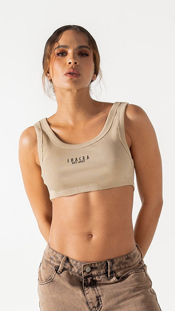 Beige athletic crop top with "SHACRA" logo, fashionable and comfortable activewear for women.
