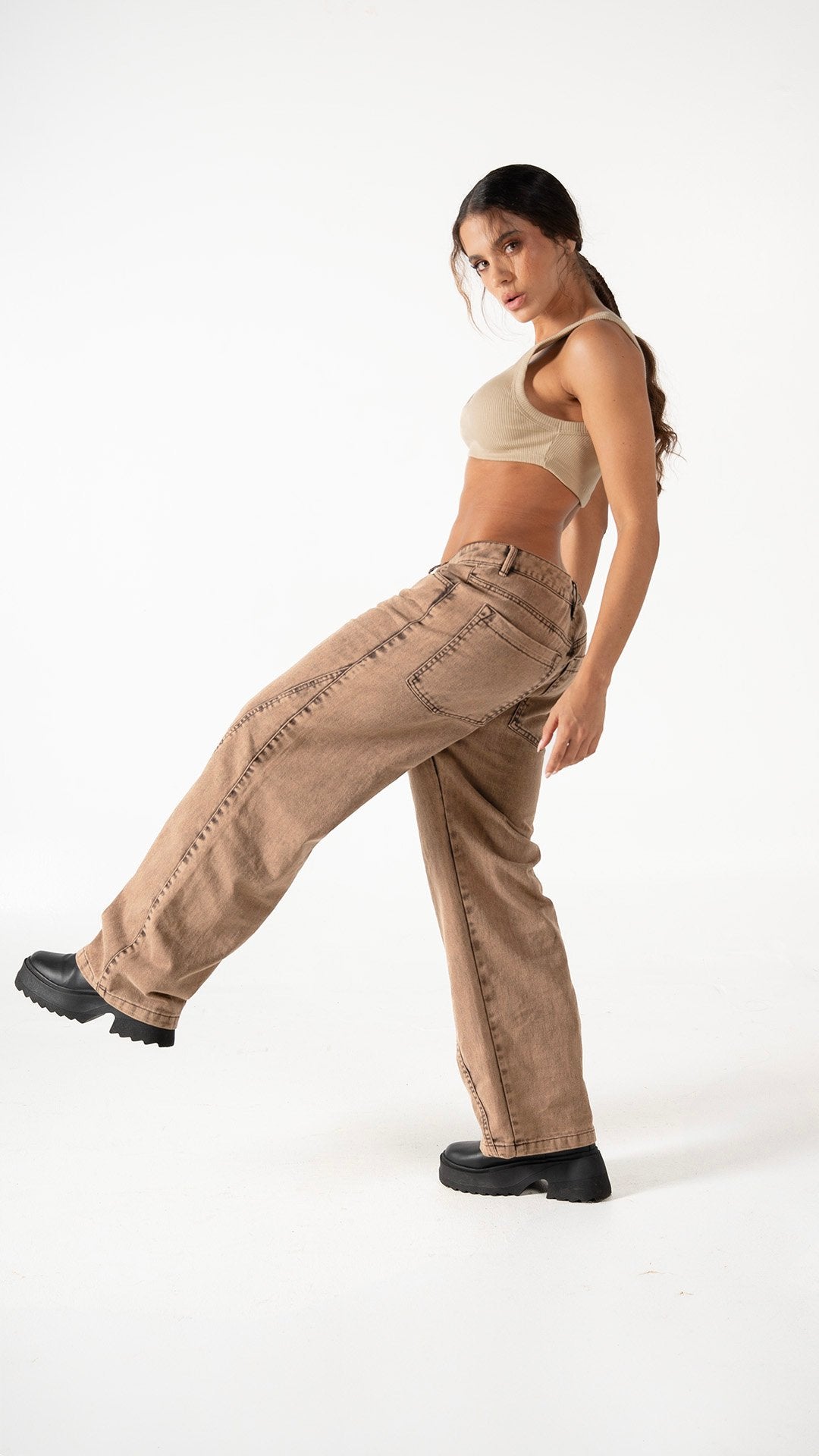 Wide-leg beige jeans paired with a tan crop top, showcasing casual and trendy fashion styles for women. Perfect for streetwear or relaxed outings, emphasizing comfort and style.