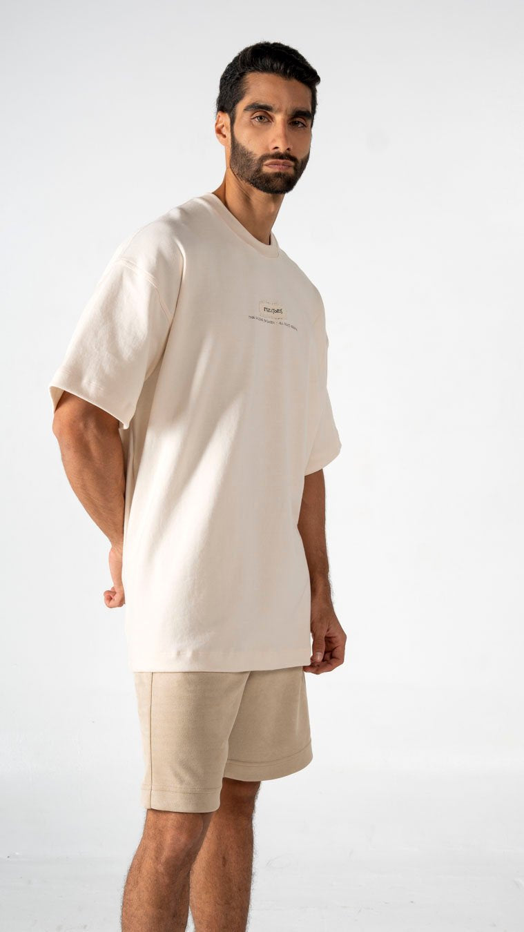 Casual beige oversized t-shirt and matching shorts outfit for men, minimal fashion styling for comfortable summer wear, streetwear look by Shacra.