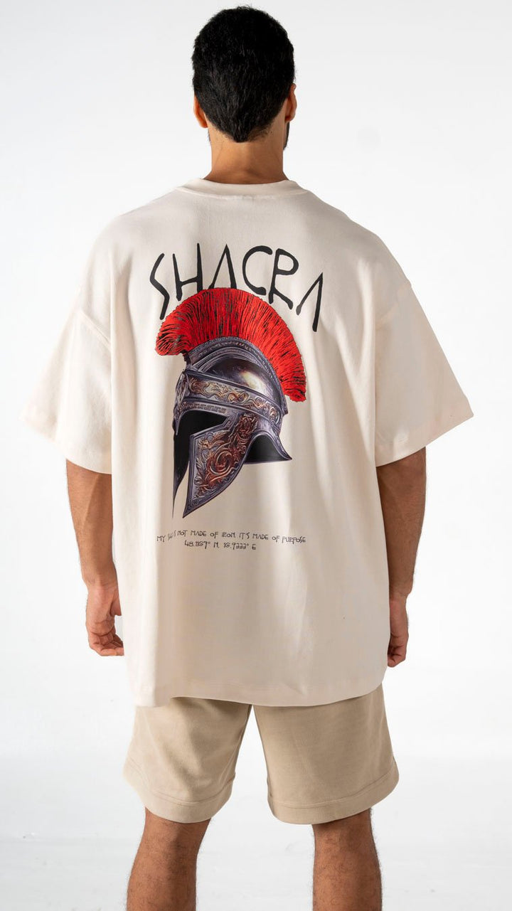 Vivid graphic t-shirt featuring a Roman helmet with a red crest and the word “SHACR” in bold letters, showcasing modern streetwear fashion and artistic design.