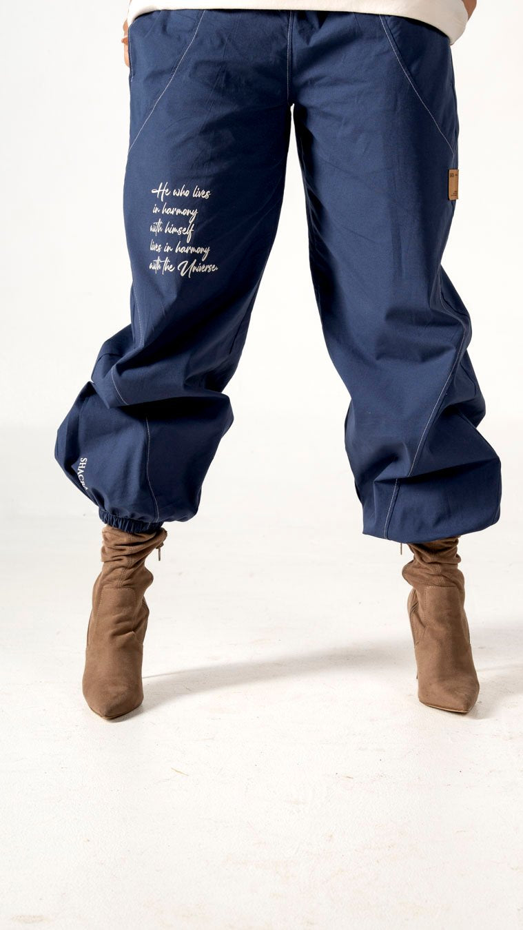 Comfortable navy blue jogger pants with motivational quote, ideal for athleisure or casual wear, paired with stylish beige boots, showcasing trendy women's fashion and versatile activewear.