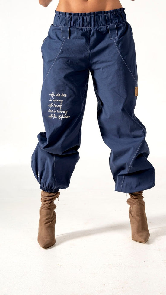 Relaxed fit navy blue cargo pants with inspirational embroidery, elastic waistband, and ankle cuffs, perfect for casual wear or street style outfits.