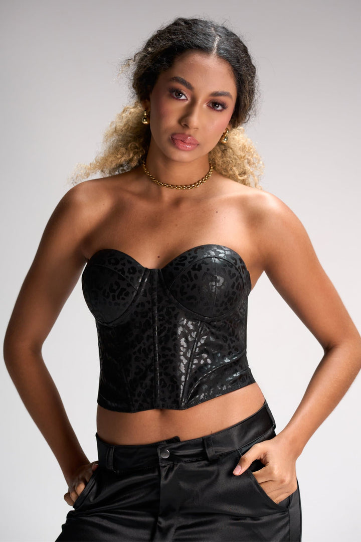 Leopard print black strapless leather corset top fashion model neutral background.
