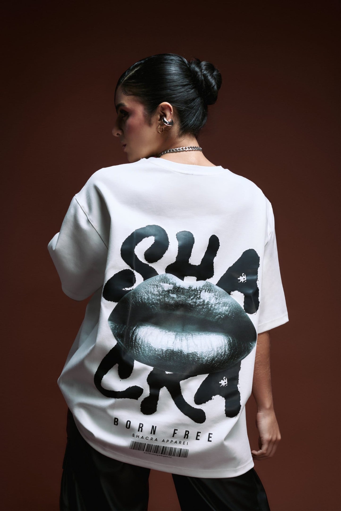 Bold white T-shirt featuring a graphic design with lips and artistic text, showcasing modern streetwear fashion by Shacra for a trendy, edgy look.