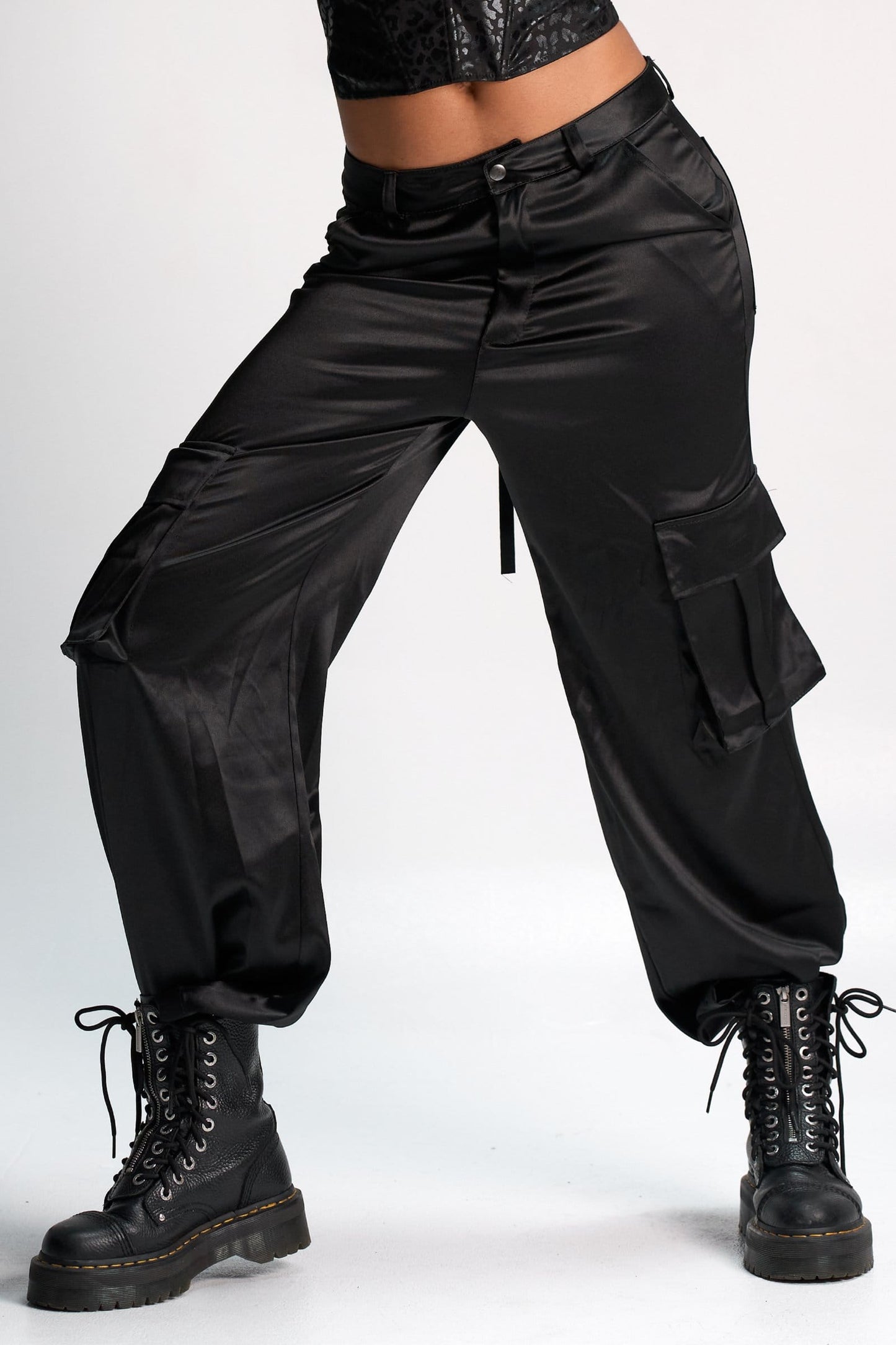 Shacra black satin cargo pants paired with combat boots, showcasing edgy streetwear fashion with high-quality material and trendy design. Perfect for modern, stylish everyday wear.