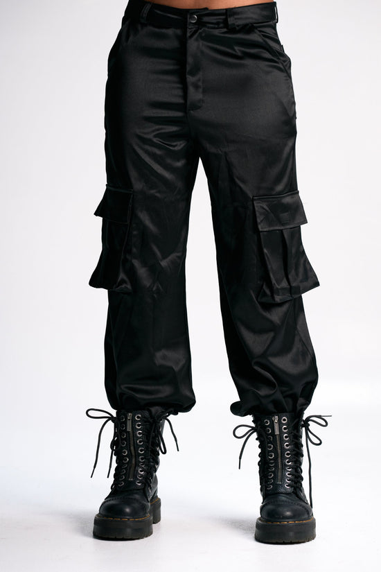 Cargo pants with lace-up combat boots in black satin fabric, stylish and trendy streetwear ensemble. Perfect for casual, edgy fashion looks.
