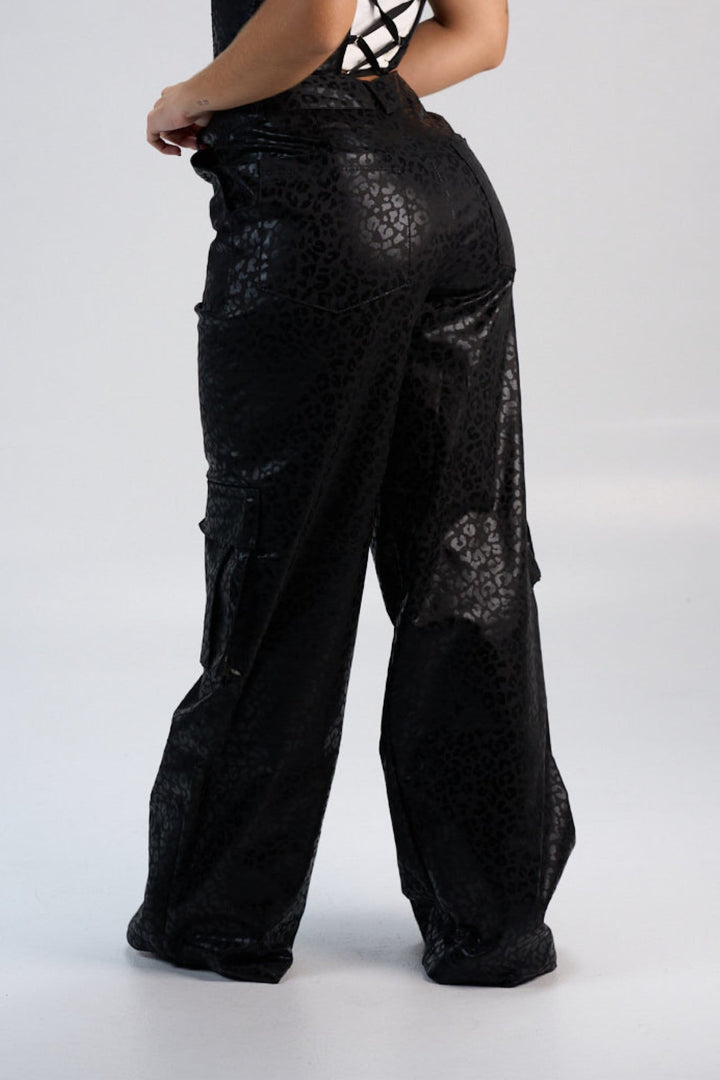 Black leopard print wide-leg pants from Shacra, showcasing trendy high-fashion streetwear with bold animal print design. Perfect for making a stylish statement.