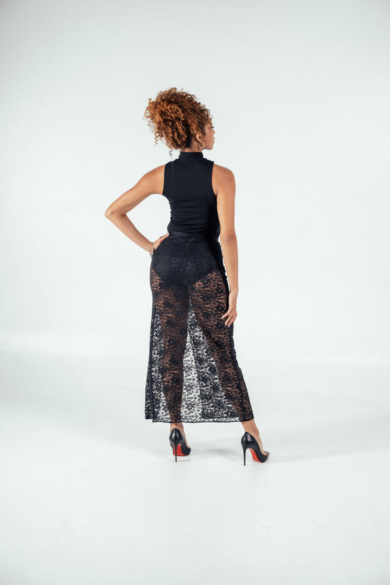 Elegant woman wearing black lace mesh skirt and high heels, showcasing fashionable plus size clothing for women. Perfect for stylish and confident fashion statements.