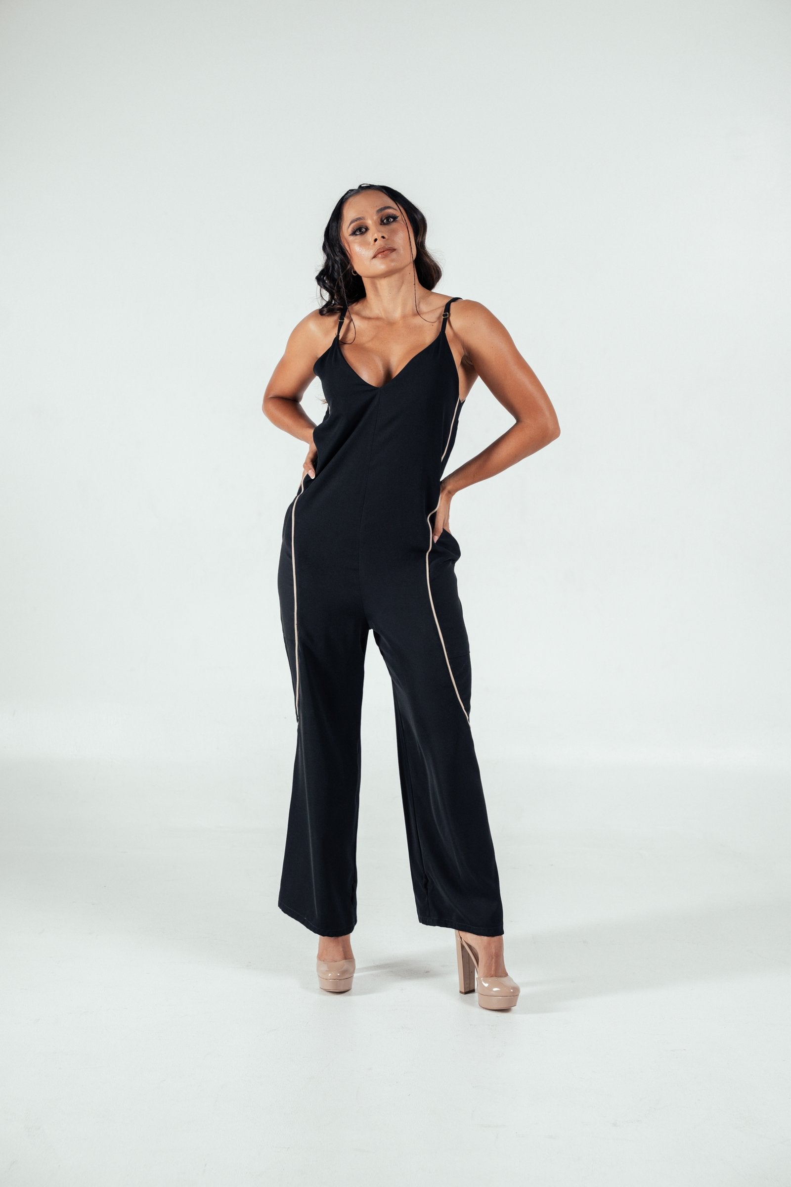 Black satin jumpsuit with gold piping, spaghetti straps, and wide-leg design perfect for stylish evening wear.