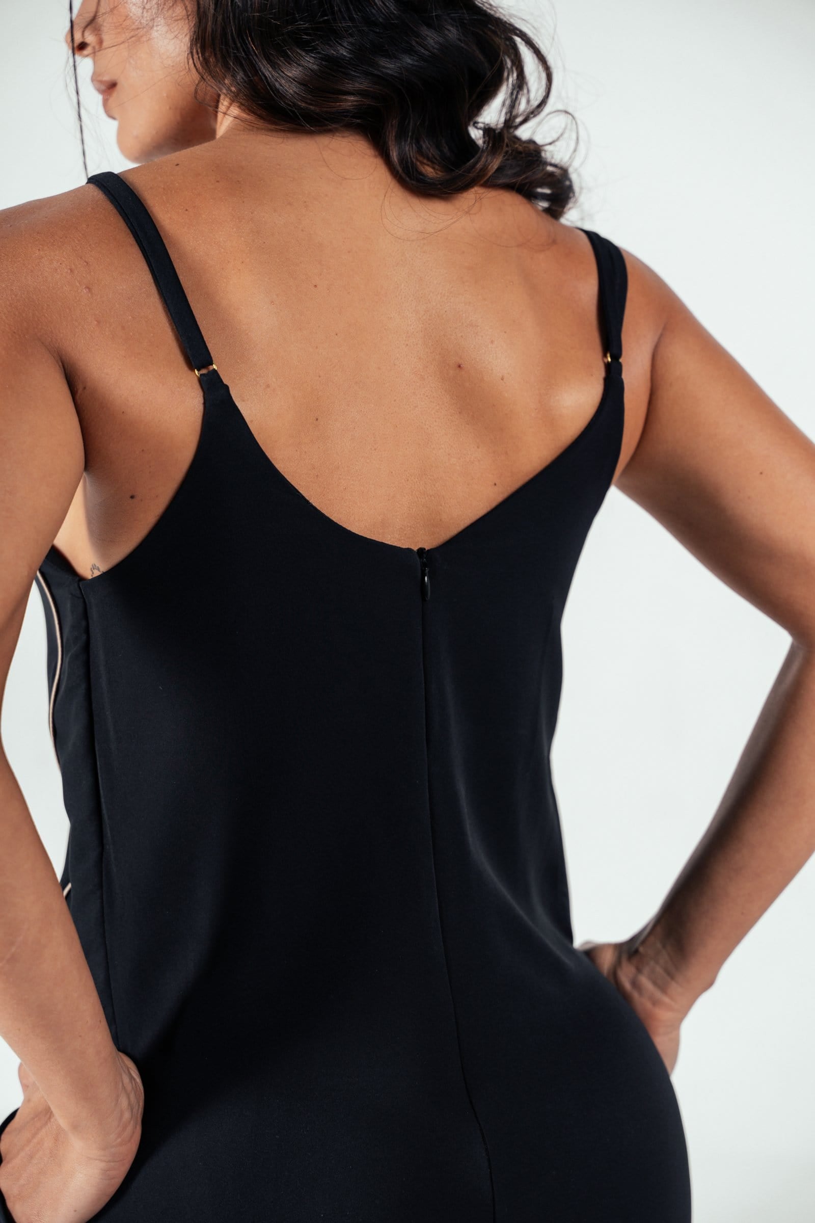 Elegant black satin slip dress with a back zipper, adjustable straps, and a fitted silhouette, perfect for stylish and comfortable wear for various occasions.