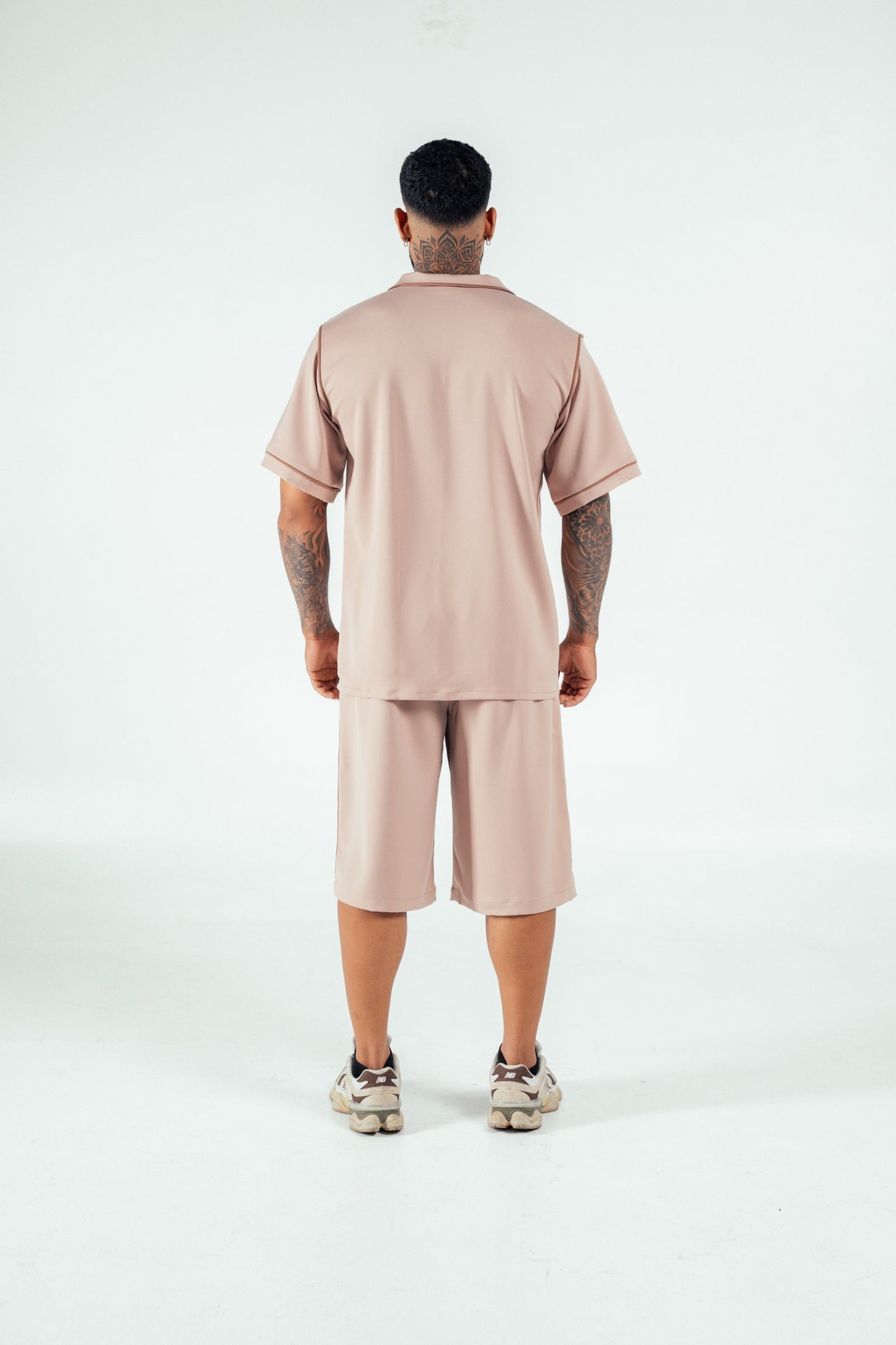 Comfortable beige loungewear set featuring a relaxed fit shirt and shorts, perfect for casual wear and lounging around at home. Stylish and comfortable athleisure from Shacra.