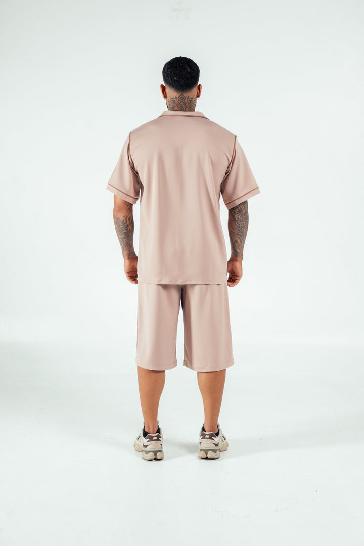 Comfortable beige loungewear set featuring a relaxed fit shirt and shorts, perfect for casual wear and lounging around at home. Stylish and comfortable athleisure from Shacra.