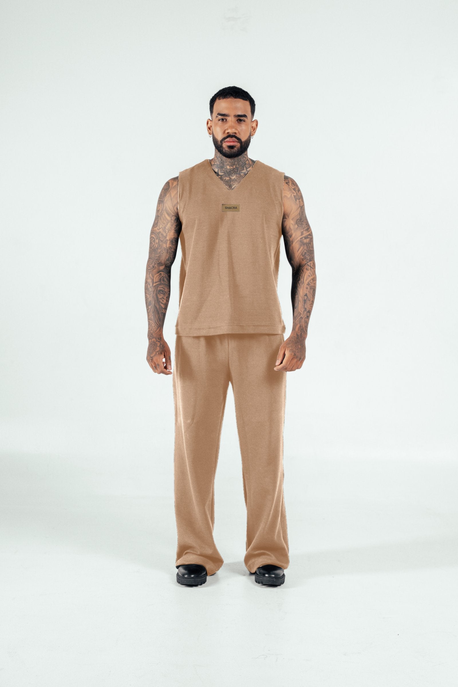 Comfortable beige loungewear set featuring a sleeveless top and matching pants, perfect for casual or at-home wear, with a stylish and relaxed fit.