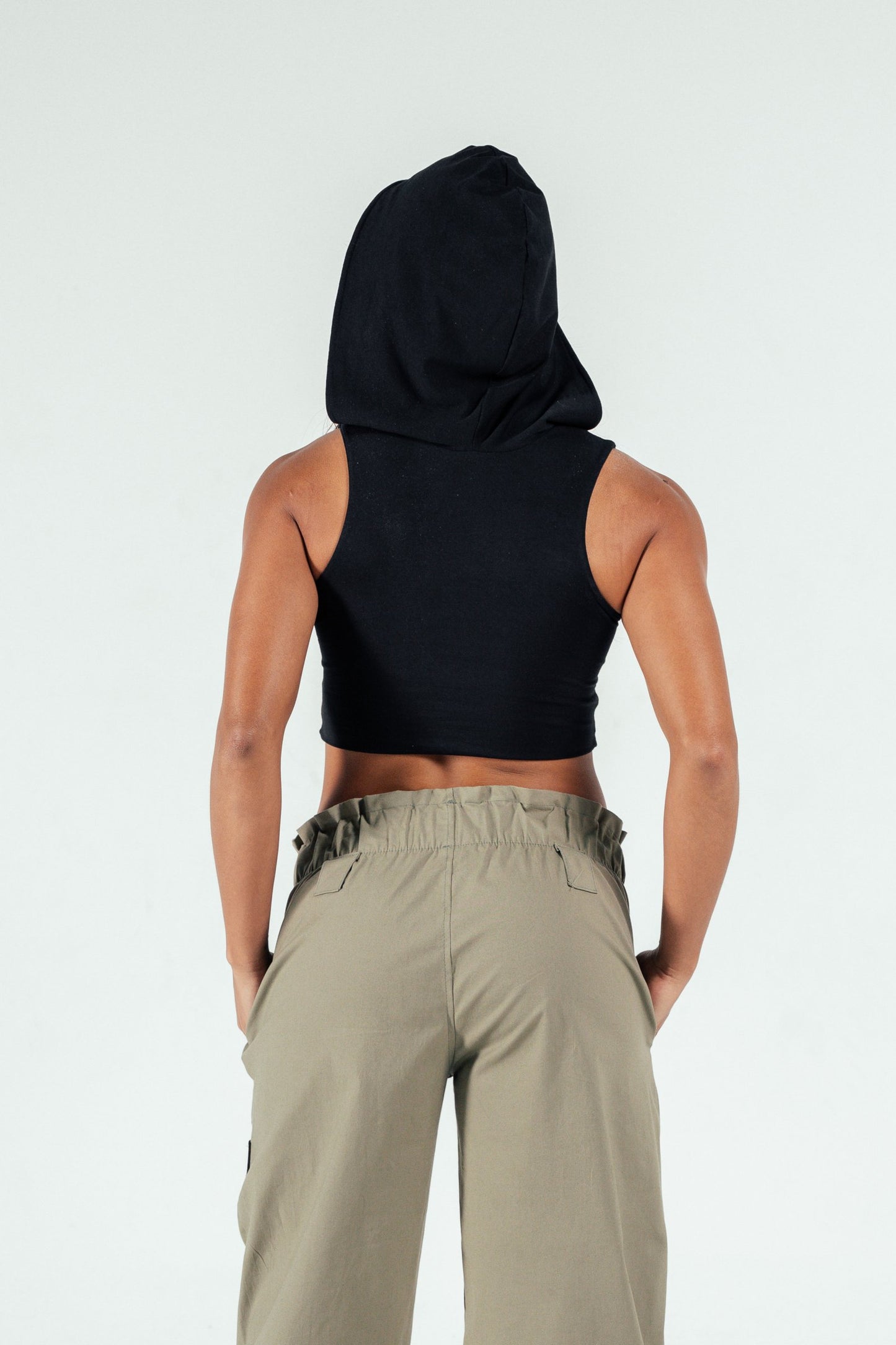 Black hooded sleeveless crop top with casual style for modern fashion.