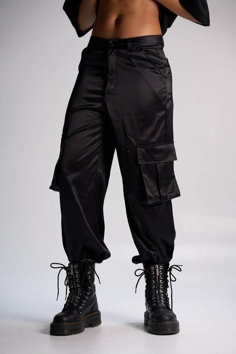 Black cargo pants with trendy oversized pockets, paired with combat boots for a bold streetwear look. Perfect for fashion-forward, casual style and versatile everyday wear.