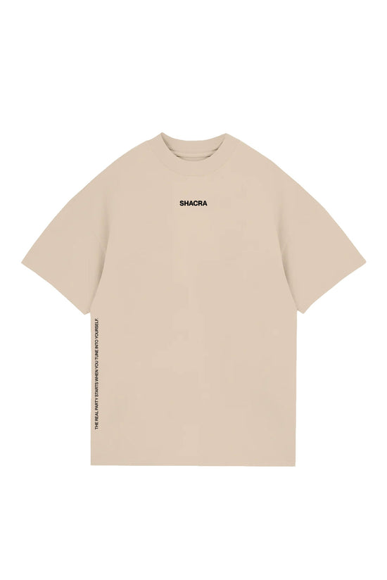 Vegan beige oversized t-shirt with minimal black text logo "SHACRA" on the chest and motivational quote on the side seam, perfect for casual streetwear and sustainable fashion.