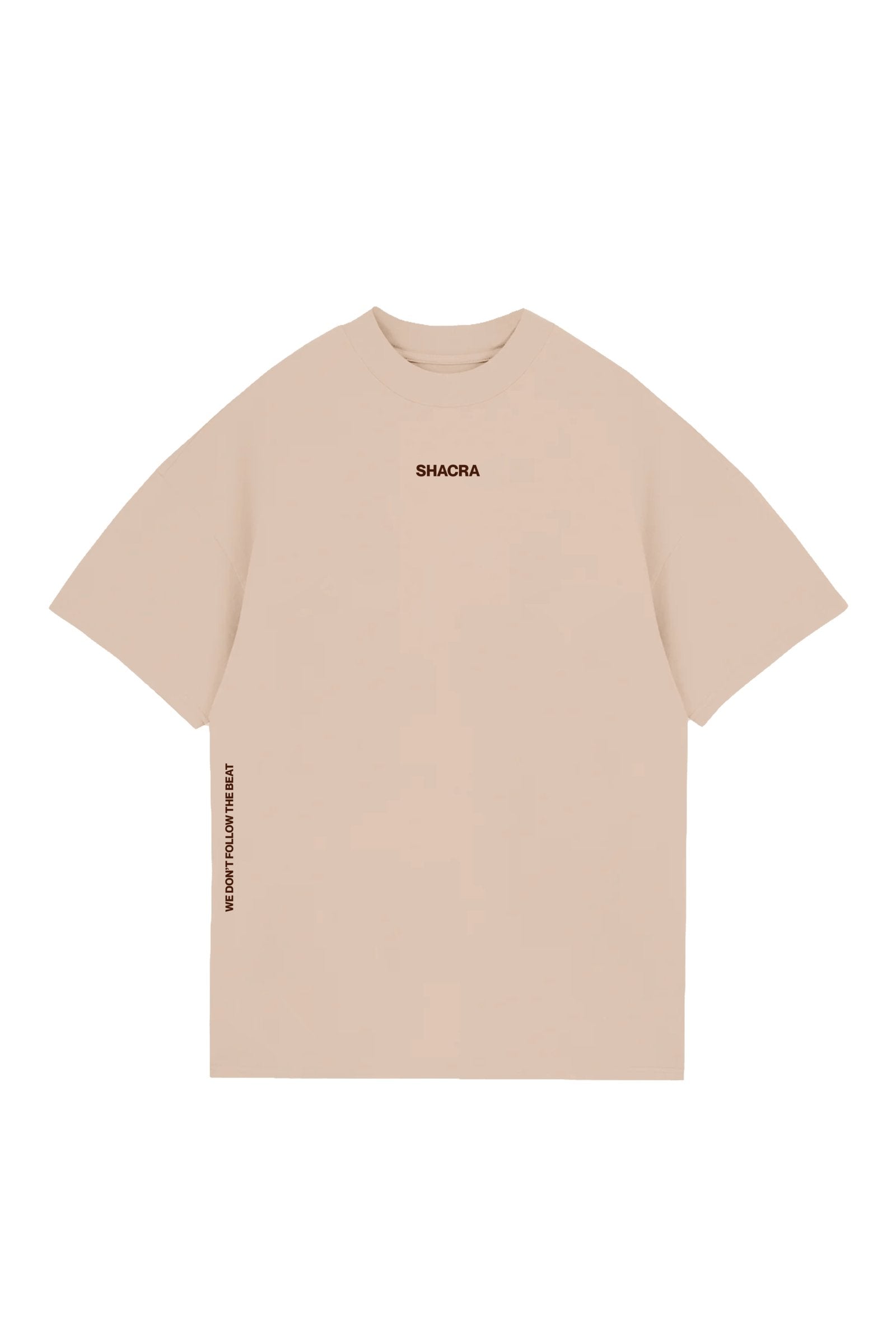 Comfortable beige T-shirt with "SHACRA" logo on the chest and motivational phrase "WE DON'T FOLLOW THE BEAT" on the side. Perfect casual wear for music and lifestyle enthusiasts.