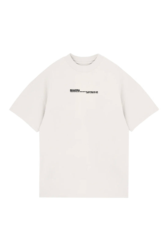 Minimalist white T-shirt featuring black "Shacra" logo and inspirational quote, perfect for casual wear and street style. Designed for comfort and style, showcasing unique branding.