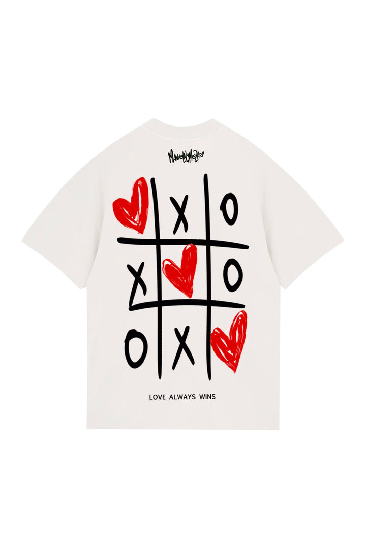 Hand-painted graphic Tic Tac Toe T-shirt featuring hearts and the phrase "Love Always Wins" for a trendy, love-inspired style.