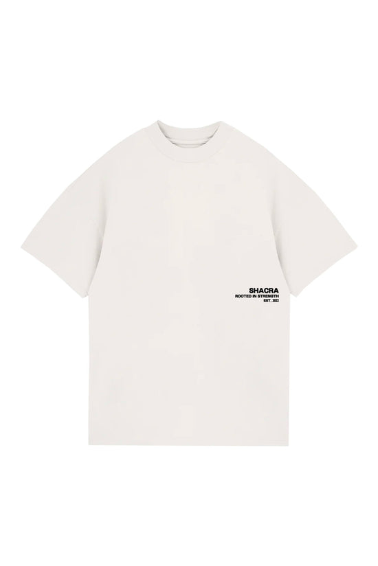 Comfortable white T-shirt with black "SHACRA Rooted in Strength" logo, perfect for casual wear and street style.