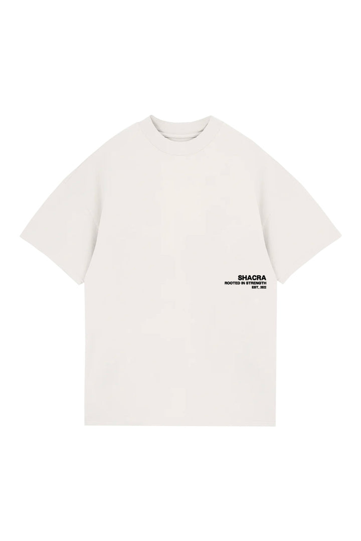 Comfortable white T-shirt with black "SHACRA Rooted in Strength" logo, perfect for casual wear and street style.
