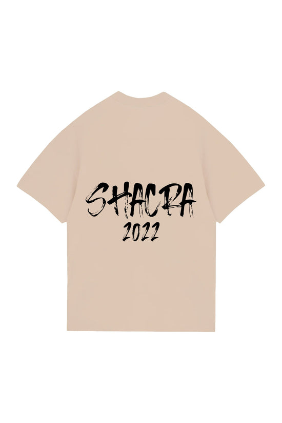 Black distressed text saying "SHACRA 2022" printed on a beige t-shirt.