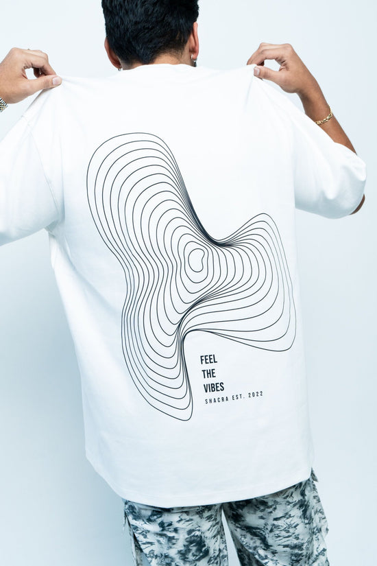 Contour line design on a white T-shirt with text "Feel the Vibes" by Shacra, highlighting contemporary fashion and stylish graphic apparel.